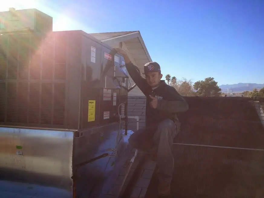 HVAC technician performing AC Tune-Up on a rooftop unit in Lake Bluff